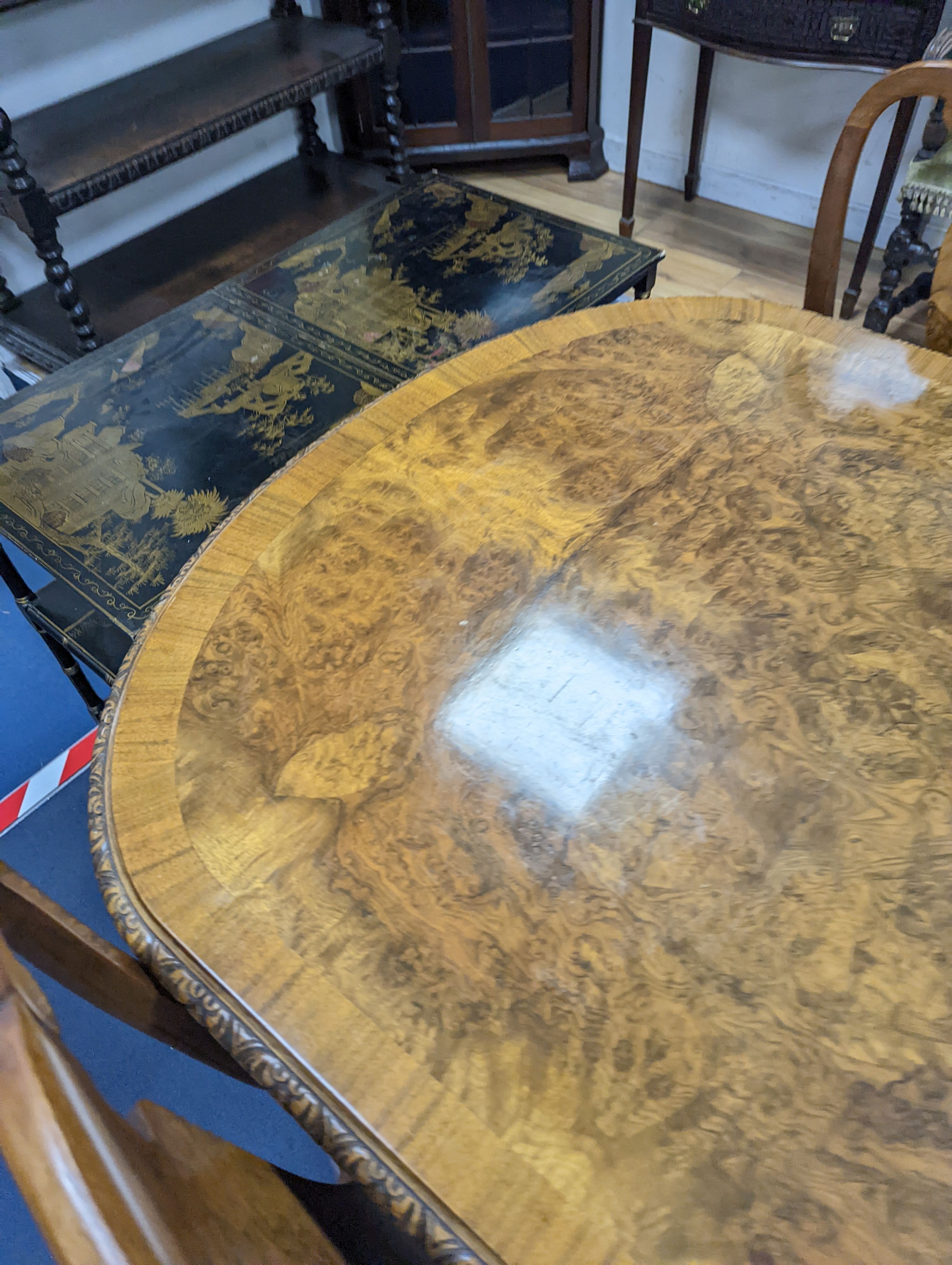 A Queen Anne revival burr walnut dining suite, comprising serpentine sideboard, length 168cm, depth 56cm, height 98cm, extending dining table, 210cm extended, one spare leaf, width 90cm, height 75cm and eight chairs, two